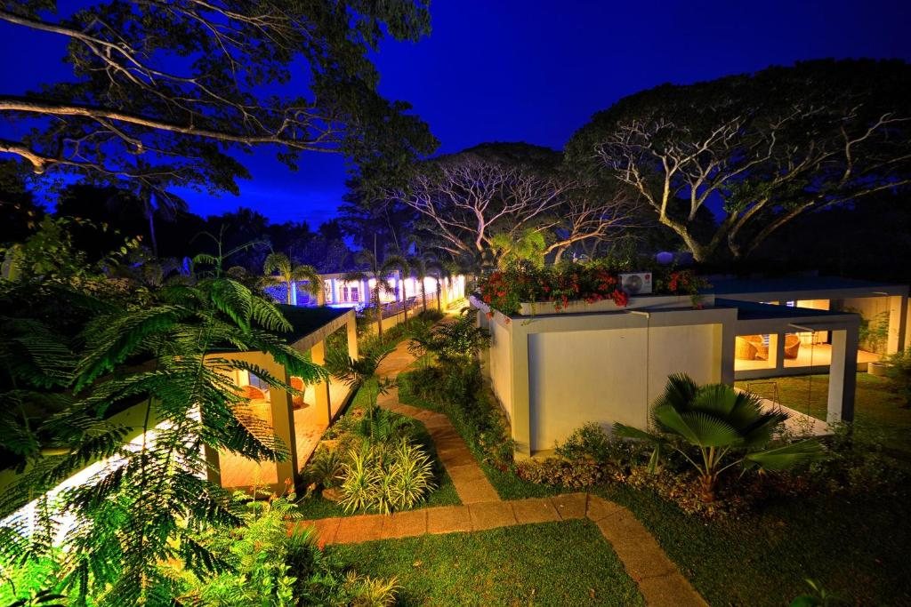 Aerial view of Munting Paraiso's bungalow walkways and gardens lit up at night