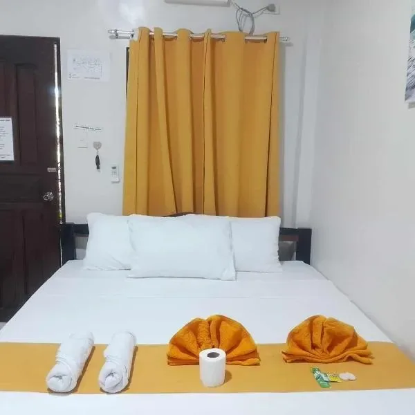 Another guest room glimpse at The View - Jungle Lodges, Port Barton, showing the bed made up with white linens and folded towels